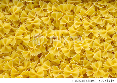farfalle macaroni background with pasta. A view from the top, a close-up of a texture. farfalle macaroni background with pasta. A view from the top, a close-up of a texture. 39931516