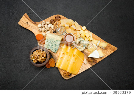 various types of cheese - brie, camembert, roquefort and cheddar on wooden board various types of cheese - brie, camembert, roquefort and cheddar on wooden board 39933379