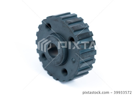Close-up of a crankshaft gear on an isolated white background. New spare parts Close-up of a crankshaft gear on an isolated white background. New spare parts 39933572