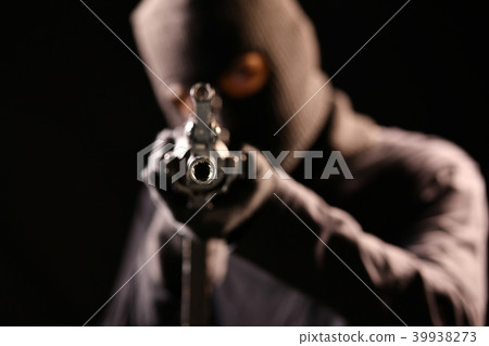 The Robber aiming rifle on black background 39938273