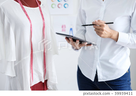 Stylish fashion designer working with measure red dummy as sketc 39939411