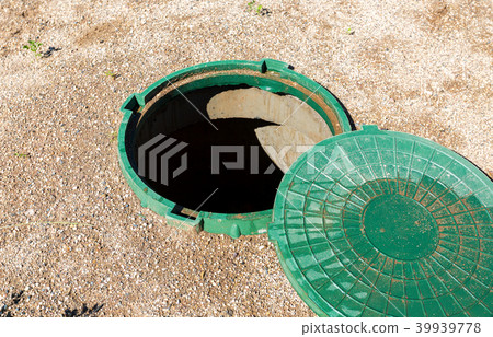 Opened unsecured sewer manhole of rural septic  39939778