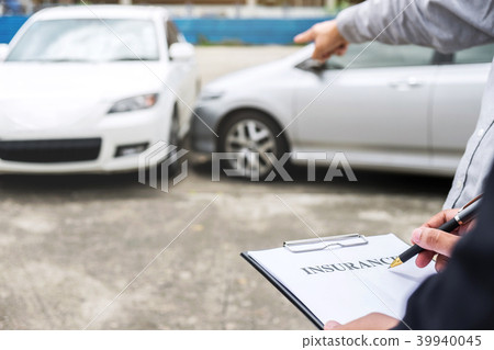 Insurance Agent examine Damaged Car and filing Report Claim Form Insurance Agent examine Damaged Car and filing Report Claim Form 39940045