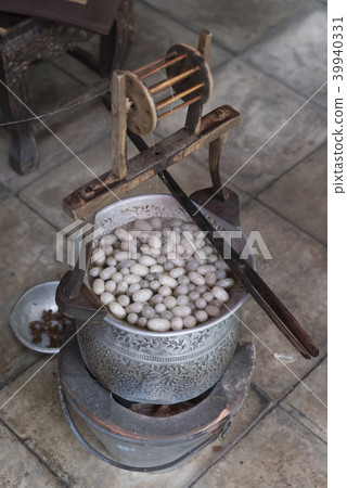 Boiling silkworm cocoon in the pot with hot water Boiling silkworm cocoon in the pot with hot water 39940331