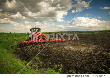 Tractor plowing fields. Preparing land for sowing. Tractor plowing fields. Preparing land for sowing. 39940549