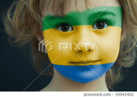 Child with a painted flag of Gabon Child with a painted flag of Gabon 39942402
