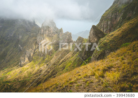 Impressive rugged mountain range overgrown with verdant grass. Xo-Xo Valley. Santo Antao Island Impressive rugged mountain range overgrown with verdant grass. Xo-Xo Valley. Santo Antao Island 39943680