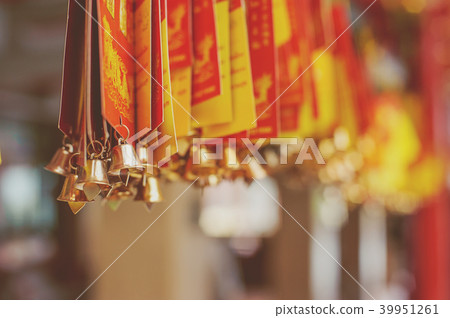 Paper hanging with gold bells used for writing ble 39951261