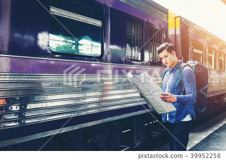 Tourist man backpacker using map to travel Tourist man backpacker using map to travel 39952258