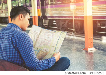 Tourist man backpacker using map to travel Tourist man backpacker using map to travel 39952259