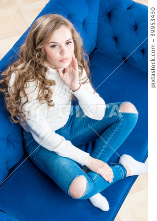 cute girl in a warm sweater on the couch cute girl in a warm sweater on the couch 39953430