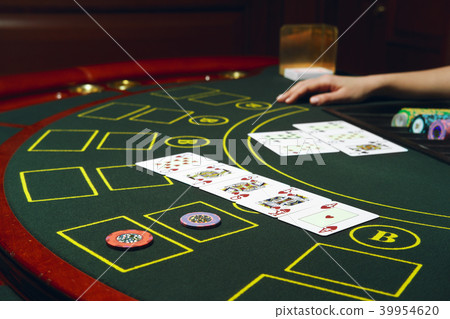 Casino black jack table with chips and cards.  39954620