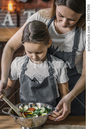Girl and mother making salad 39957806