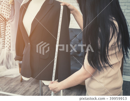 Fashion Designer hand is measuring jacket length Fashion Designer hand is measuring jacket length 39959913