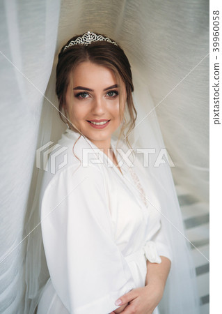 Portrait of the bride in a negligee under the white curtain 39960058