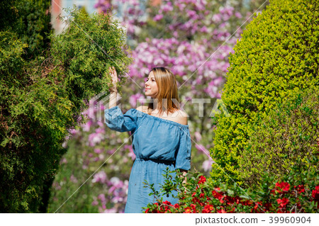 girl in springtime blossom garden. 39960904