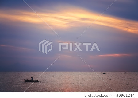 Small fisherman boat sailing at dusk 39961214