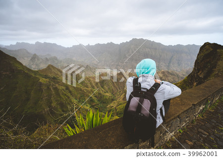 Traveler enjoying magnificent view of huge mountain range on Santo Antao island, Cape Verde Traveler enjoying magnificent view of huge mountain range on Santo Antao island, Cape Verde 39962001