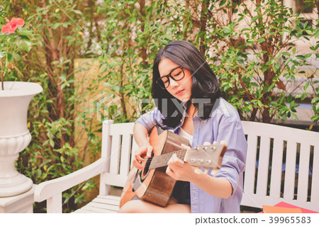 Music Concepts. Asian girls playing guitar. Asian women relaxing 39965583