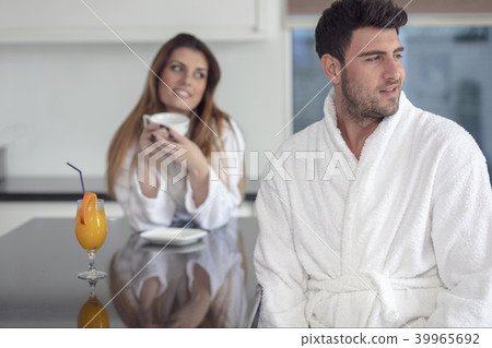 Portrait of a man and his wife in the kitchen while having breakfast Portrait of a man and his wife in the kitchen while having breakfast 39965692