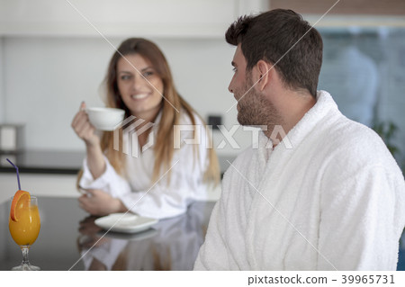 Portrait of a man and his wife in the kitchen while having breakfast Portrait of a man and his wife in the kitchen while having breakfast 39965731