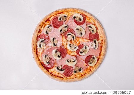 Pizza with salami ham and mushrooms isolated  39966097