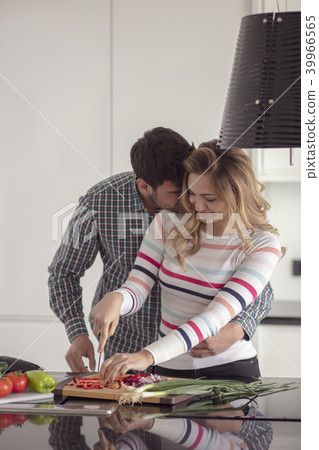 Portrait of happy young couple cooking together in the kitchen at home. Portrait of happy young couple cooking together in the kitchen at home. 39966565