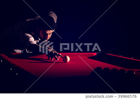 A man with a beard plays a big billiard. 39966576