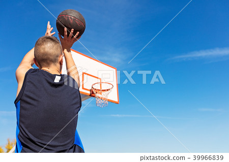 Young man shooting free throws from the foul line 39966839