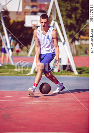 Handsome male playing basketball outdoor 39967018