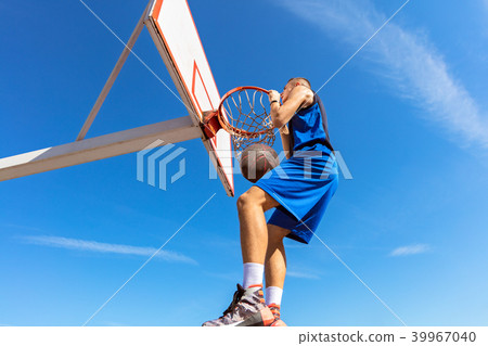 Slam Dunk. Side view of young basketball player making slam dunk Slam Dunk. Side view of young basketball player making slam dunk 39967040