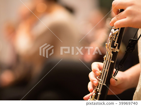 Oboe player performing in an orchestra 39969740