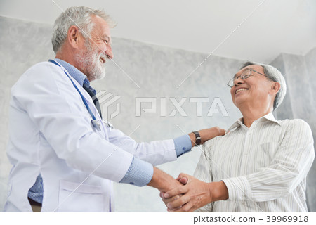 Senior male Doctor is handshaking to Asian male patient. 39969918