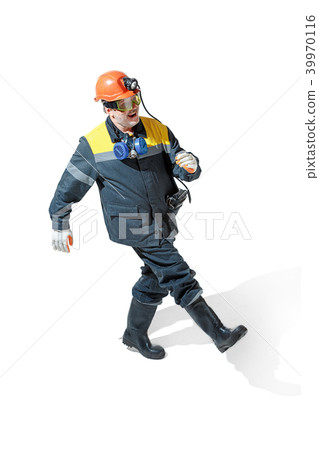 The studio shot of senior bearded male miner standing at the camera on a white background. 39970116