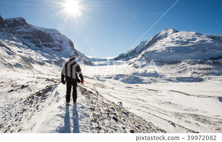 Young man hiking at Athabasca Glacier 39972082