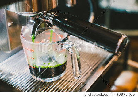 Coffee machine making hot green tea 39973469