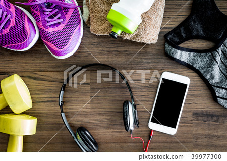 Fitness equipment on wooden background 39977300