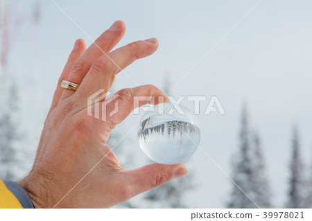 Transparent glass ball reflecting a frozen winter Transparent glass ball reflecting a frozen winter 39978021