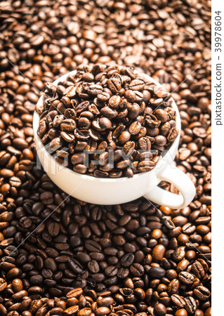 Brown coffee beans in white cup Brown coffee beans in white cup 39978604