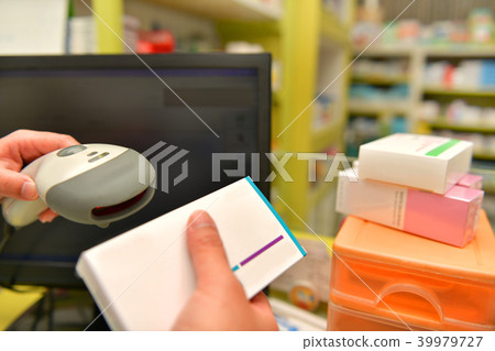 Pharmacist scanning barcode of medicine 39979727