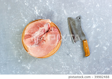 Raw cut of pork shoulder on board with knife 39982488
