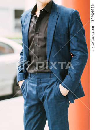 Man wearing a suit posing at outdoor. Man wearing a suit posing at outdoor. 39984656