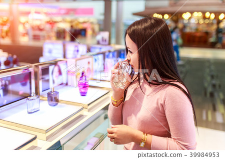 Asian woman testing and choose to buy perfume Asian woman testing and choose to buy perfume 39984953