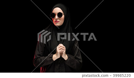 Portrait of beautiful stylish young muslim woman wearing black hijab and sunglasses as modern 39985220