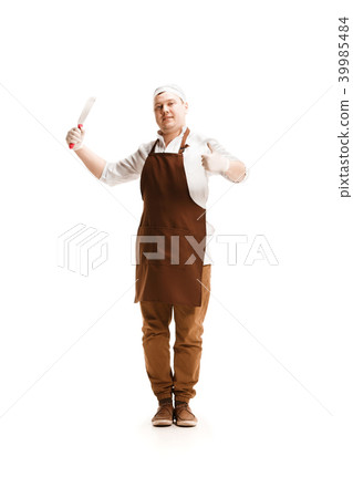Smiling butcher posing with a cleaver isolated on white background Smiling butcher posing with a cleaver isolated on white background 39985484