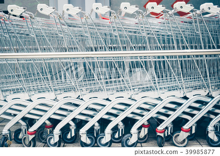 Row of supermarket trolleys. Row of supermarket trolleys. 39985877