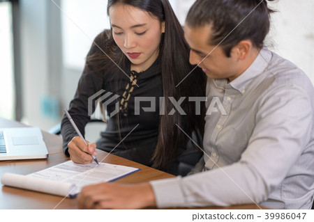 Beautiful secretary helping boss in office. 39986047