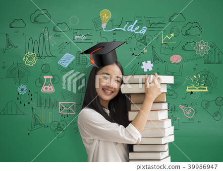 women student holding book with graduation hat women student holding book with graduation hat 39986947