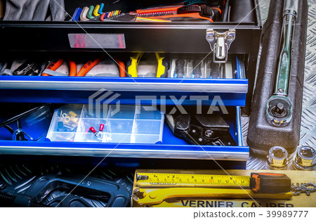 Tools in box on checkered plate background 39989777