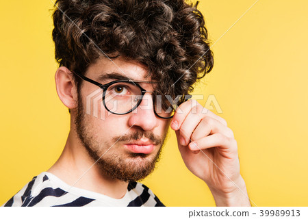 Studio portrait of a young man a yellow background. Studio portrait of a young man a yellow background. 39989913